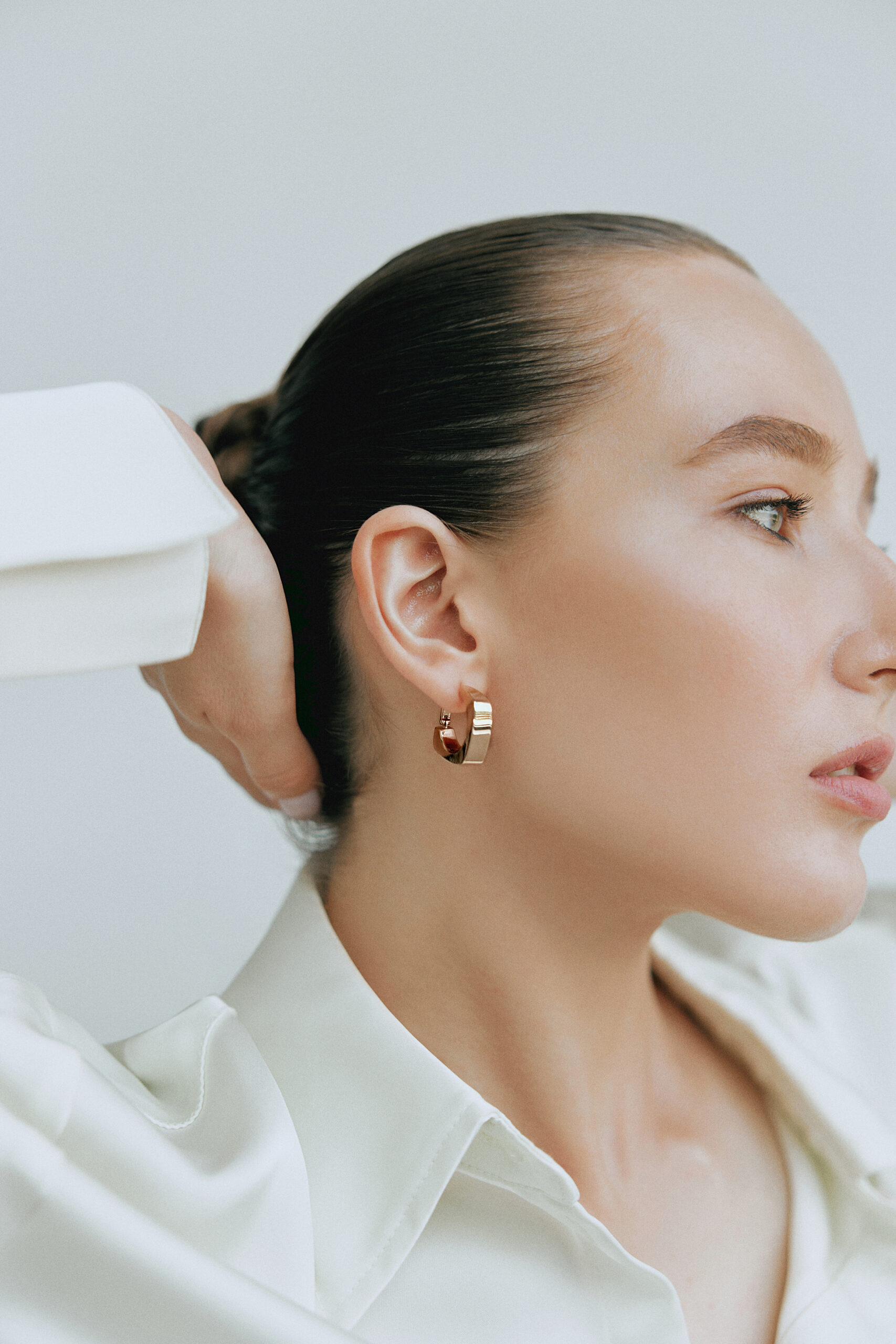 Profile portrait wearing ZODI earrings